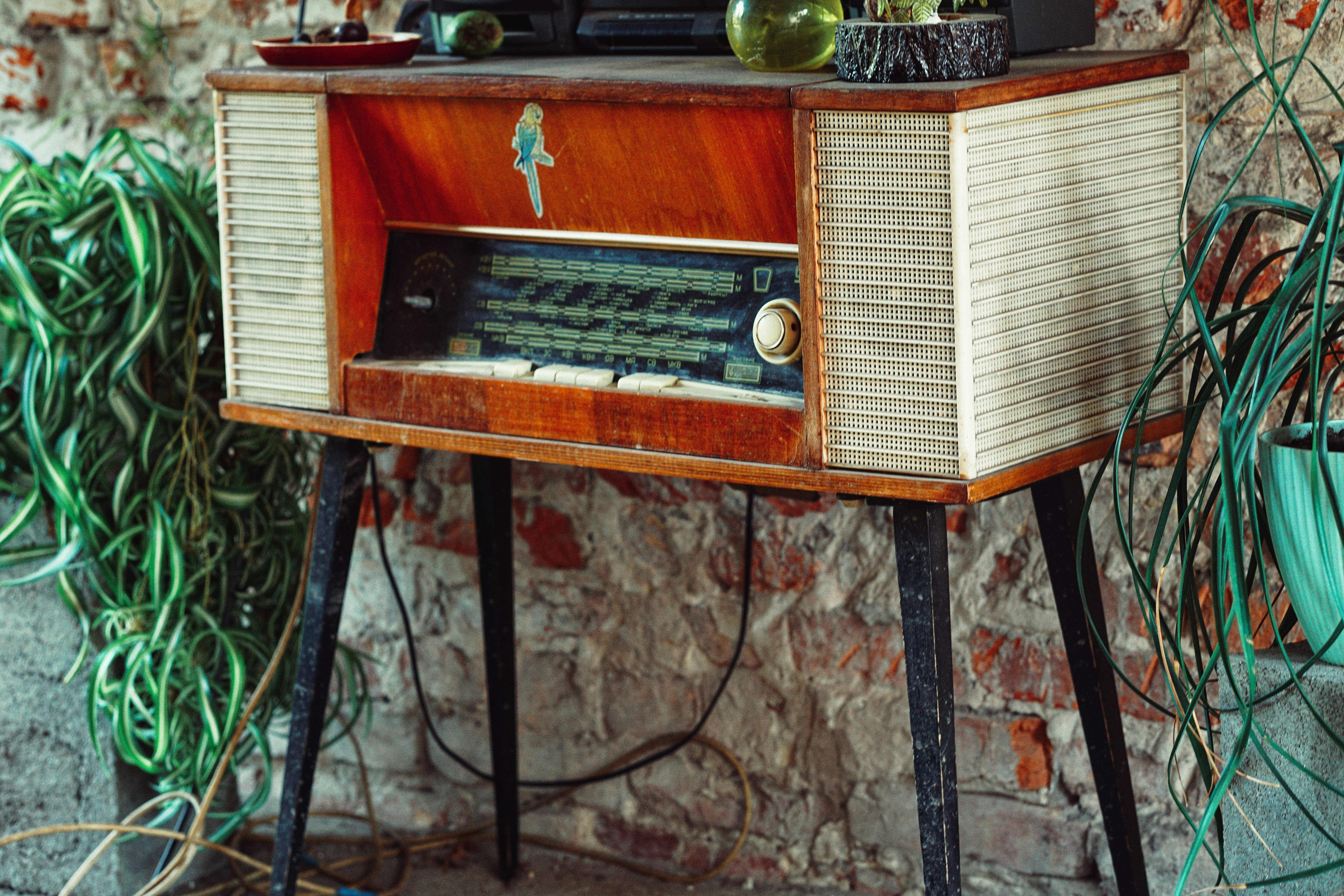 brown and silver radio on brown wooden table